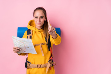 Wall Mural - Young traveler caucasian woman isolated showing number one with finger.