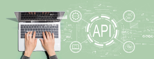 API - application programming interface concept API concept with person using a laptop computer