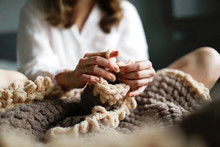 Caucasian Woman Knits Large Toy Rug With Hands