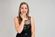 Universal concept horizontal portrait of a woman on a white background. A photo of a pretty smiling girl with long hair and excellent make-up in a black dress stands in different poses.