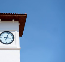 White Clock Tower On A Background Of Blue Sky. Time To Rest.