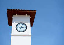White Clock Tower On A Background Of Blue Sky. Time To Rest.