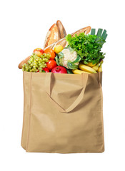 Eco friendly reusable shopping bag filled with bread, fruits and vegetables on a white background