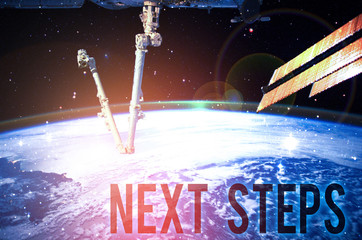 Writing note showing Next Steps. Business concept for something you do after you have finished doing first one Elements of this image furnished by NASA