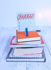 Poster - Conceptual hand writing showing Grammar. Concept meaning whole system structure language syntax and morphology pile stacked books notebook pin color reminder white wooden