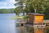 Fototapeta Łazienka - View of a small sauna by a lake, on a jetty.
