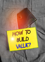 Poster - Handwriting text writing How To Build Value question. Conceptual photo Ways for developing growing building a business Small little wallet inside man trousers front pocket near notation paper