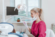 © Ксения Левашова - Female dentist in dental office treats teeth with kid patient. Indoor.