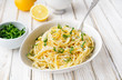 Pasta al Limone, delicious Italian meal, spaghetti with Parmesan, butter and lemon sauce, topped with fresh grated zest and cheese