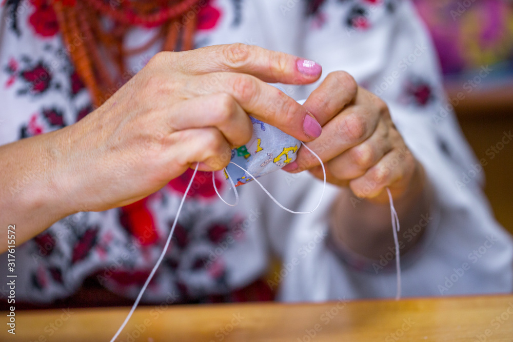 Craftsman Rag Hands of a craftsman in the Ukrainian folk costume (embroidery and ...