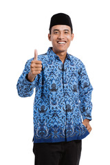 Wall Mural - smiling young man wearing batik korpri with thumbs up hands, government officials of Indonesia