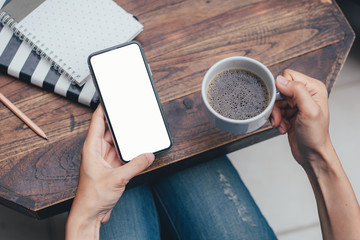 Mockup image blank white screen cell phone.man hand holding texting using mobile on desk at coffee shop.background empty space for advertise text.people contact marketing business,technology 