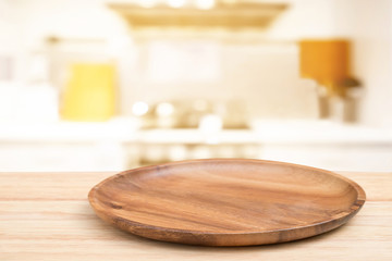 Empty wooden tray on perspective wooden table on top over blur flower background. Can be used mock up for montage products display or design layout.