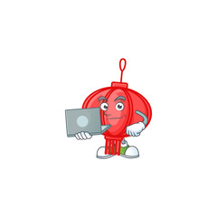 Canvas Print - A clever chinese lampion mascot character working with laptop