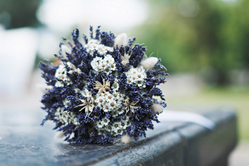 Selective focus unusual bouquet of variety of wild flowers chamomile, lavender, ears. Selective focus.