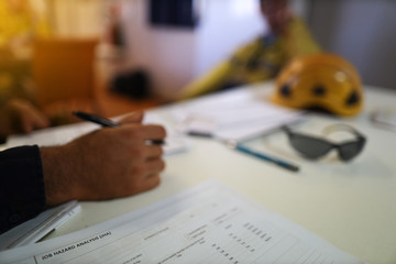 Wall Mural - job hazard analysis risk safety assessment high risk work on the table defocused co-worker, supervis
