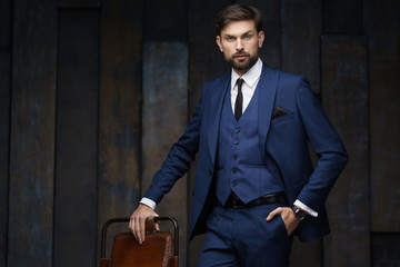 indoor photo of young handsome stylish businessman wearing suit