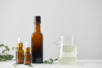 Wall Mural - bottles with aroma oil, medicines on wooden background. selective focus,horizontal.