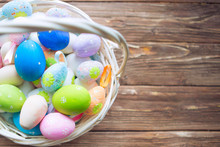 Colorful Easter Egg In The Nest On Wood Brown Background With Space.