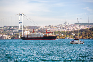 large container ship and yacht in the bosphorus strait