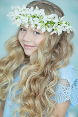 Wall Mural - Girl wreath of flowers. Girl with a wreath of flowers on her head.