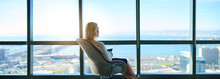 Businesswoman Sitting In An Office Looking Out At The City