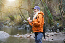 Woman Fly Fishing In River