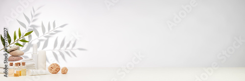 Fotografía Spa still life with creams, essential oils, towels on light background