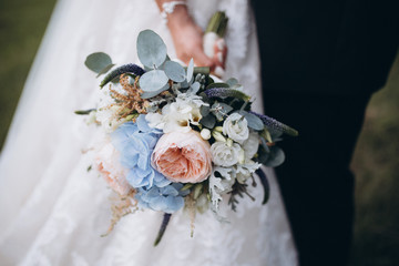 Wall Mural - beautiful wedding bouquet with red, pink and white flowers, roses and eucalyptus, peonies, calla lilies