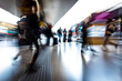 people in the station as they walk fast, blurred photo