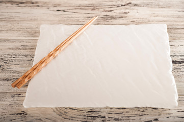 Closeup table setting by February 14th. Romantic dinner for two in chinese style and copy space. Empty sushi dishes with chopsticks.