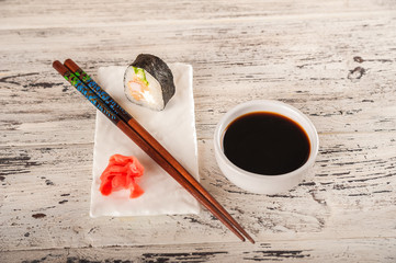 Closeup table setting by February 14th. Romantic dinner for two in chinese style and copy space. Rolls are held with chopsticks.