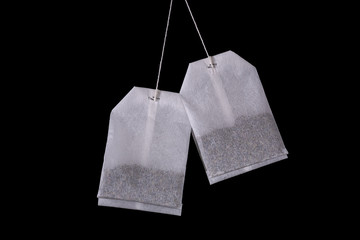 Two tea bags on a black background