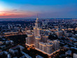 Aerial view of the skyscraper in Moscow at night, night city on the background, sunset in the sky.