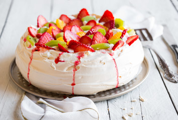 Delicious Pavlova cake with meringue and fresh strawberries