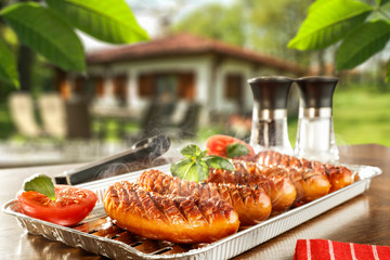 Sticker - Fresh hot grilled sausage and blurred background of garden 