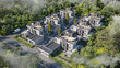 © Free_styler - Aerial view of a townhouse village / gated community with roof terrace in the foggy morning, 3d rendering