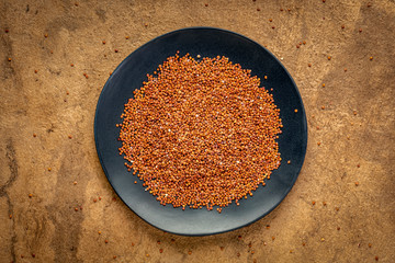 Wall Mural - red quinoa grain on ablack plate