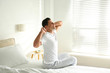 © New Africa - Man awakening on bed at home. Lazy morning