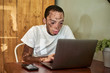© Westend61 - Young man with vitiligo working on his computer in a cafeteria