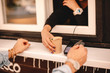 © Cavan Images - Customer making payment with credit card buying coffee on city street