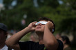 © Cavan Images - Young man looking up at solar eclipse wearing paper protective glasses