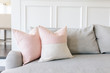© Cavan Images - Pink pillows on a grey couch