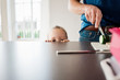© Cavan Images - father making a packed lunch for school whilst his daughter watches