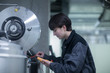 © Cavan Images - engineer woman with a device checking and controlling