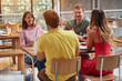 © luckybusiness - friends having fun a coffee together. people at cafe talking laughing and enjoying their time