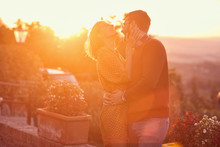 Man And Woman Hugging And Kissing At The Sunset