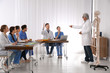 © New Africa - Medical students and professor studying human skeleton anatomy in classroom