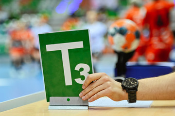 Wall Mural - Time sign T3 on the referee table during handball match.