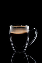 black coffee in a glass transparent cup on a black background